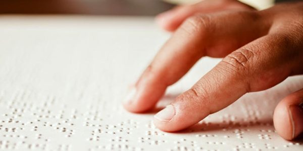 a hand reading braille