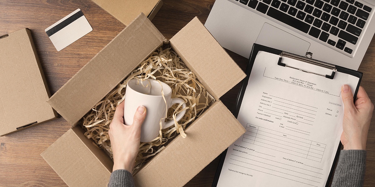 flat-lay-woman-preparing-cyber-monday-package